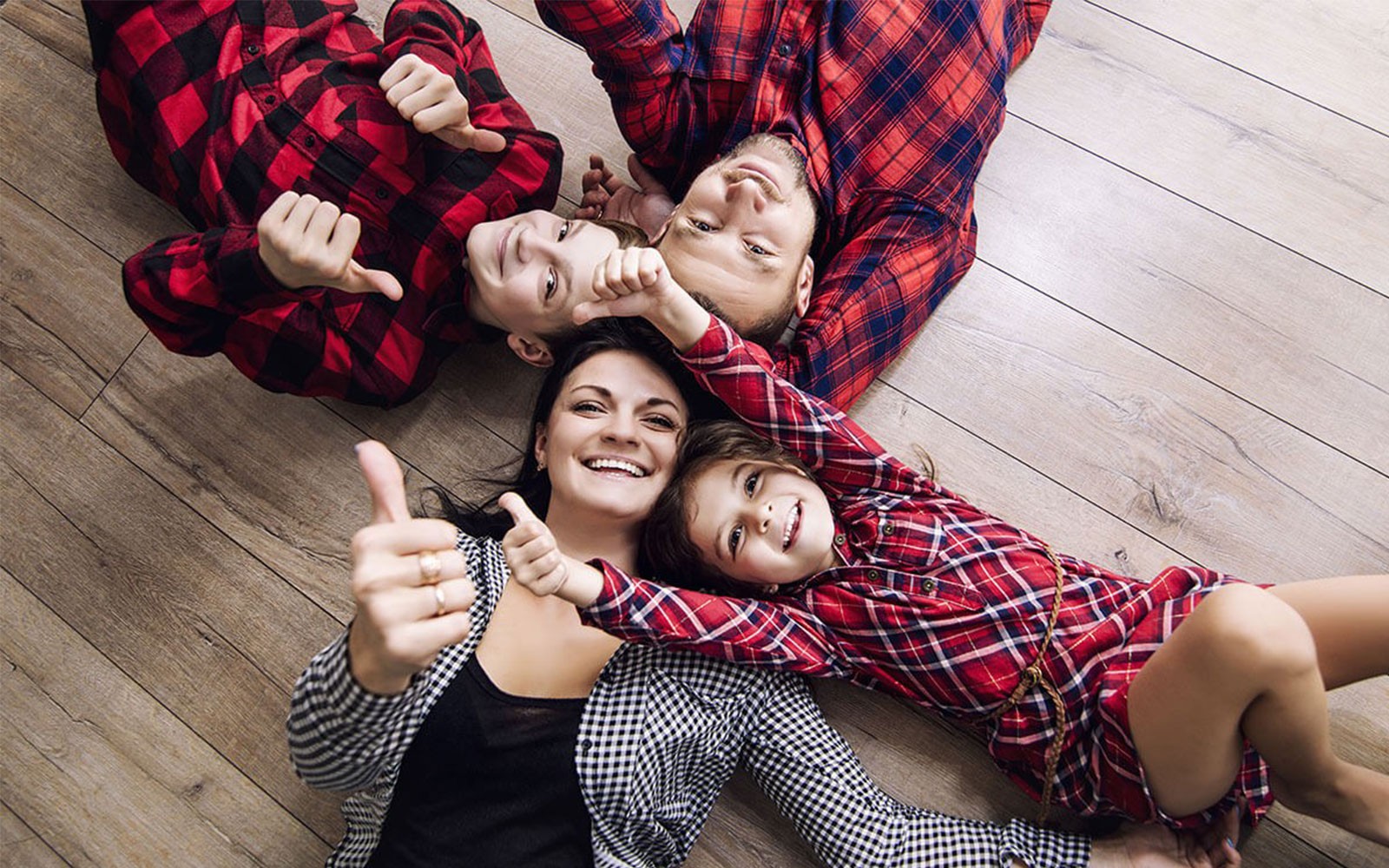 Family laying on carpet floor | JCB Interiors
