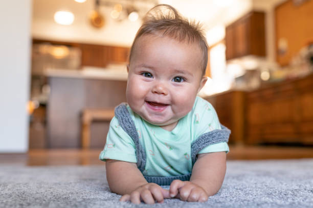 Baby laying on carpet floorings | JCB Interiors